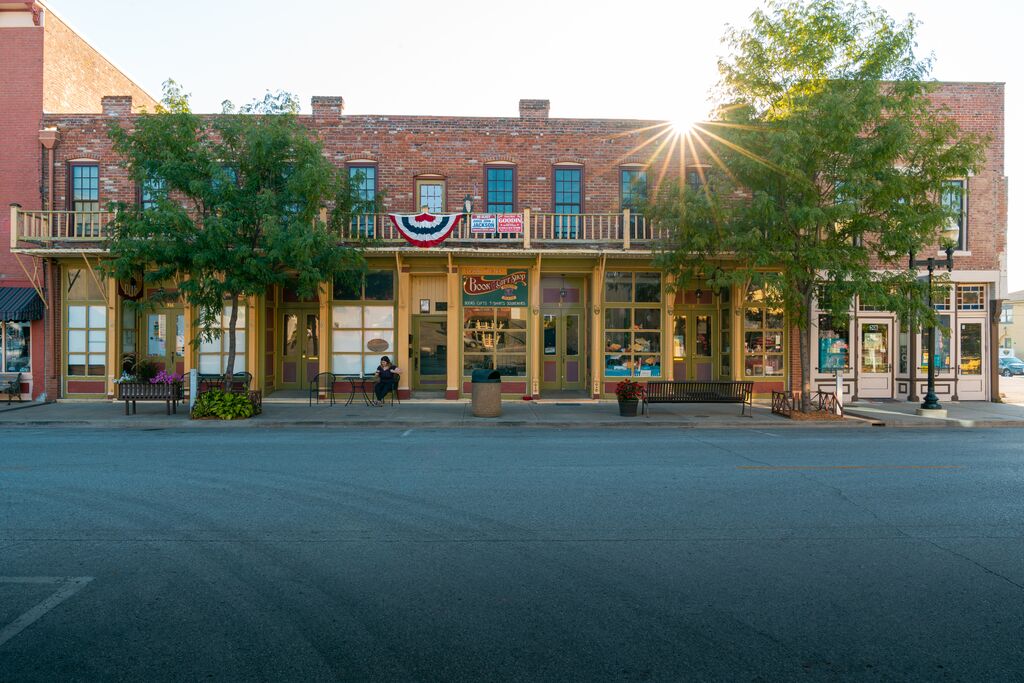 Historic downtown Hannibal building façade adorned with bunting, bathed in morning light.